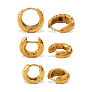 Set of three classic gold-plated hoop earrings in different sizes on white background
