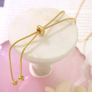 Macro detail of 18k gold plated snake chain necklace with adjustable sliding bead clasp