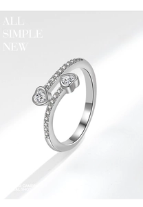 Detailed close-up of interlocking heart-shaped zircon stones and pavé diamonds on ring