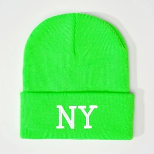 Close-up of neon green knit beanie featuring white NY embroidery and ribbed texture