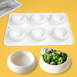 Detailed macro view of 6-cavity white silicone mold for mousse cakes and handmade soaps