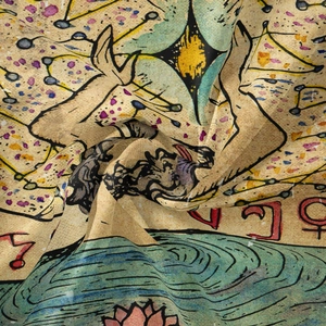 Detail of bohemian tapestry featuring astrology symbols and lotus pattern on soft fabric