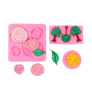 Detailed pink silicone molds for fondant roses, leaves and sunflowers with clay samples