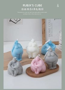 Artistic collection of diverse female body shaped candles on wooden trays in home setting