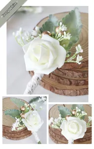 Detail of cream white artificial rose boutonniere with greenery and white rope handle
