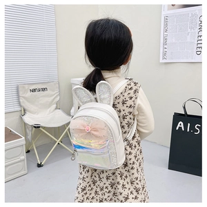 Detailed view of white kids sequin bunny backpack with bow worn by a child