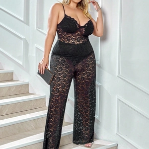 Close-up of intricate black lace hollow-out details and deep V-neckline on the bodysuit