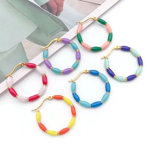 Flat lay of colorful enamel bamboo hoop earrings in gold plated stainless steel