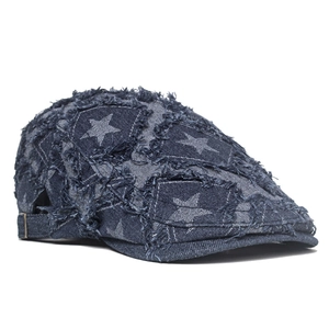 Détail de la casquette en denim bleu avec écussons étoiles et boucle métallique réglable