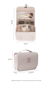 Detail view of large capacity beige hanging toiletry bag with clear mesh compartments