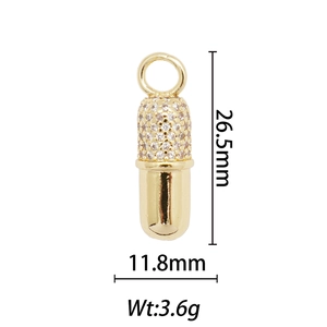 Detail view of a 18k gold capsule pendant with rhinestones including size specifications