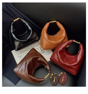 Flat lay of four dumpling bags in black, brown, wine red and coffee PU leather