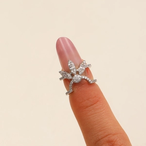 Macro detail of silver spider nail ring featuring sparkling zircon pave settings