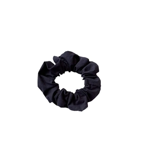 Classic black scrunchie in pleated fabric shown from a top-down view on white background