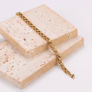 Exquisite 18K gold plated stainless steel floral chain bracelet on beige stone