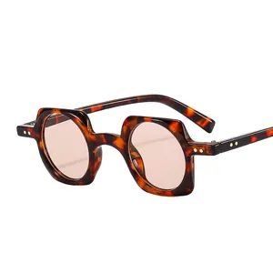 Punk tortoise square frame sunglasses with asymmetrical geometric design on white background