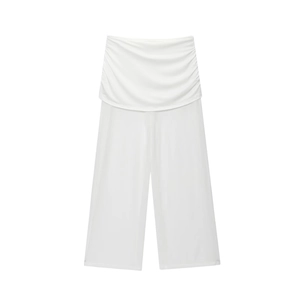 Detail of white wide-leg pants with double-layered waist design and draped fabric