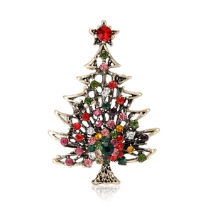Vintage gold Christmas tree brooch with colorful rhinestones and red star on white base