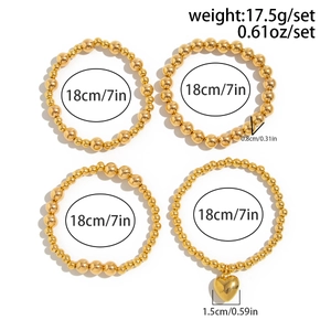 Detailed view of four-piece gold beaded stretch bracelet set with heart charm