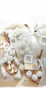White Christmas ornaments set featuring knit texture balls and candy canes in a rustic basket