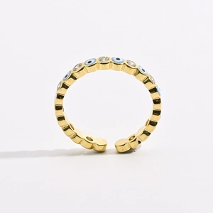 Adjustable evil eye ring in gold brass with blue and white zircons on white background