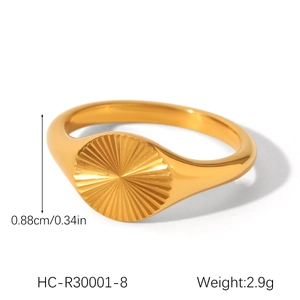 Close-up of gold stainless steel signet ring with sunburst engraving and 0.88cm width