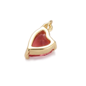 Close-up of a gold-plated heart-shaped pendant with a faceted red zircon stone