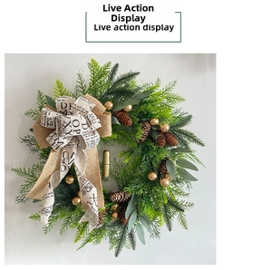 Close-up of rustic Christmas wreath with pinecones, golden bells, and a decorative burlap bow.