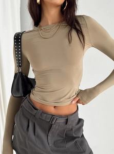 Close-up of khaki slim fit long sleeve shirt showing smooth stretch fabric on model