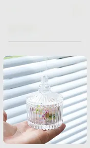 Detailed macro view of hand-blown ribbed glass candy jar with transparent lid finial