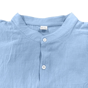 Detail view of the stand-up collar and 100% cotton fabric on this light blue men's shirt