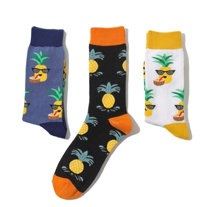Close-up of three pairs of cotton socks with cartoon pineapple wearing sunglasses