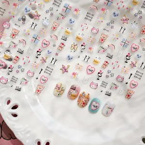 Close-up of cute cartoon nail art stickers with bears and hearts on a white plate
