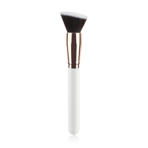 Close-up of angled foundation brush with dual-tone bristles and rose gold ferrule