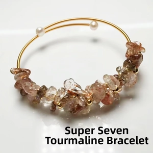Detail of 14K gold wire wrapped bracelet featuring natural Super Seven stones and pearls