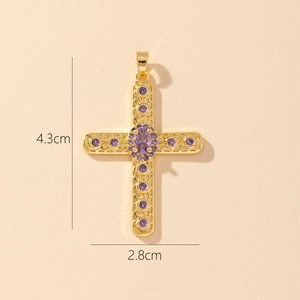 Detail view of a gold cross pendant with purple zircon and size specs 4.3cm by 2.8cm