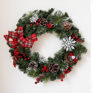 Nordic Christmas wreath with pine cones berries and a bird nest on white background