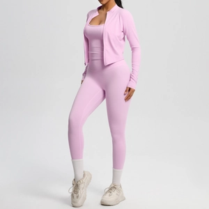 Detailed view of pink three-piece yoga set including zip jacket, sports bra, and leggings