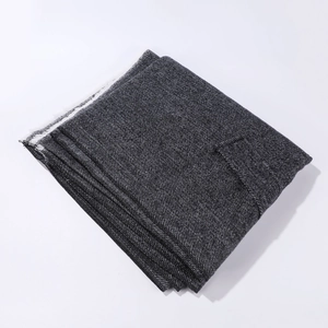 Detailed macro view of deep grey cashmere-like scarf texture and fringe tassel edge