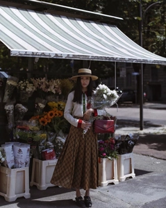 Elegant summer flat top straw hat with ribbon paired with a vintage boutique outfit