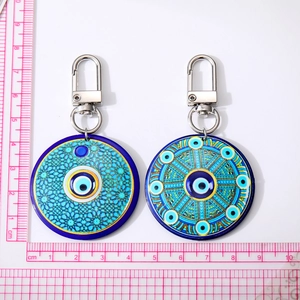 Bohemian Evil Eye keychain with round 5.5cm pendant and silver metal ring on white background