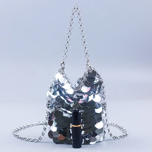 Detail of silver fish-scale sequin bag with metal chain and size reference lipstick