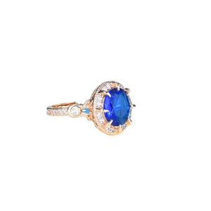 Luxury rose gold halo ring with a large oval blue sapphire and pavé diamond accents