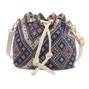 Ethnic bohemian woven bucket bag with red and blue geometric patterns and drawstring