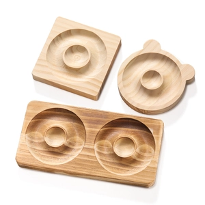 Close-up of wooden bead design trays showing natural grain and smooth round edges