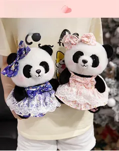 Close-up of cute plush pandas in purple and pink lace princess dresses with large bows