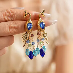 Vintage gold peacock drop earrings with blue crystal stone and multi-colored bead tassels