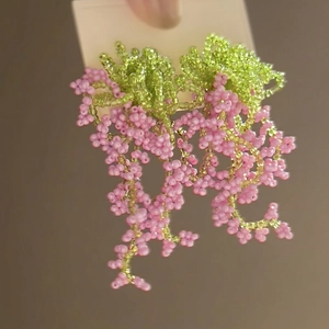 Handmade beaded floral tassel earrings in pink and green for a fresh vacation style