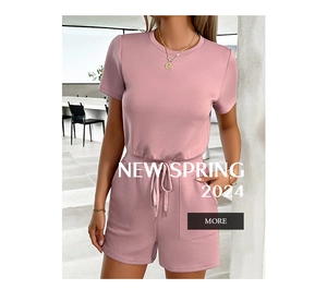 Detail of pink knit romper featuring a drawstring waist and functional side pockets