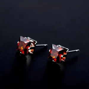 Macro shot of 8mm pink square zircon earrings with classic four-prong stainless steel setting